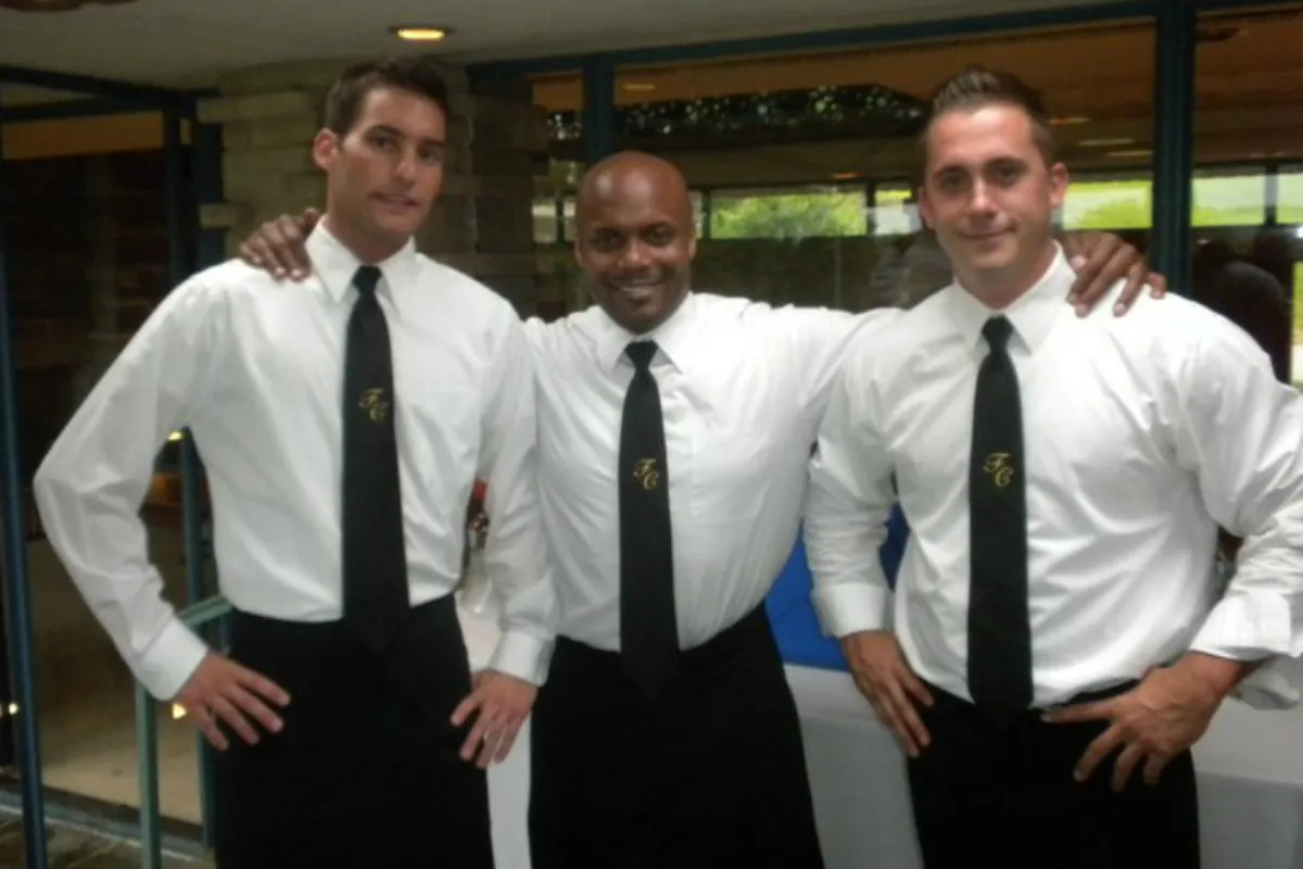 Three First Call bartenders in white shirts and monogrammed black ties